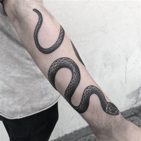 snake tattoos wrapped around arm